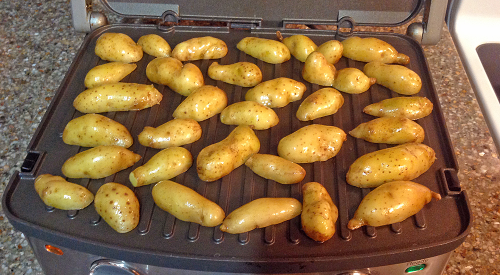 Grilling fingerling potatoes on a double-sided grill