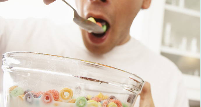 man eating large bowl of cereal