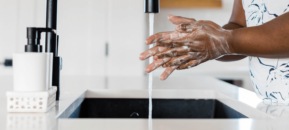 man washing hands with soap and water