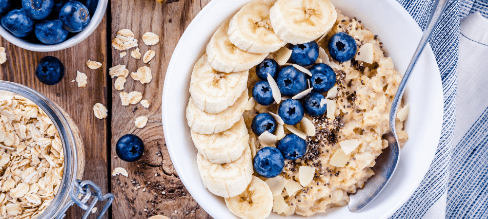 bowl of oatmeal with bananas, blueberries, and almonds