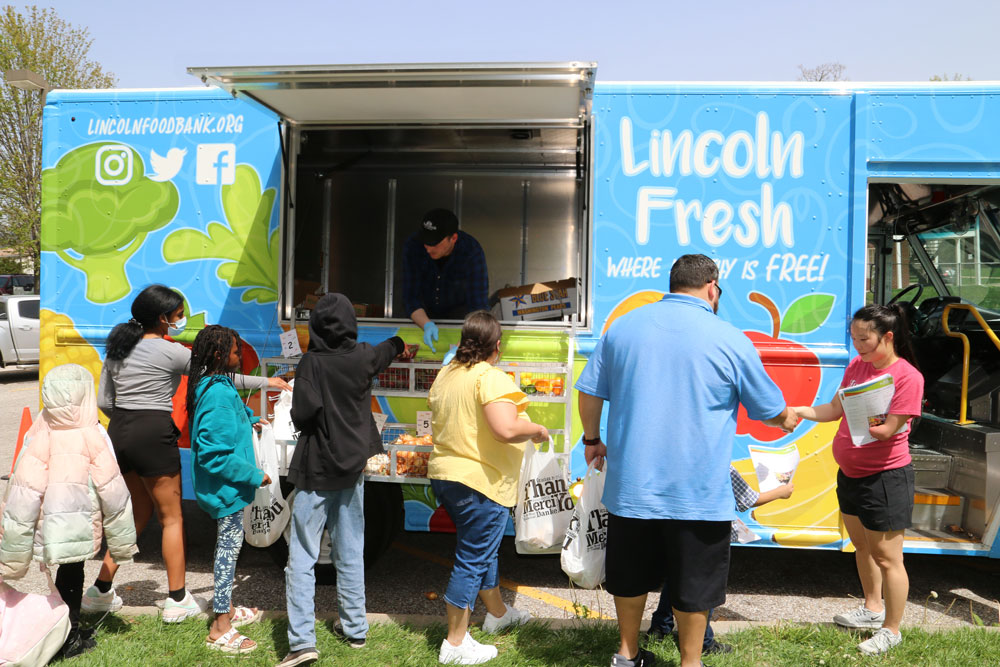 People getting fresh food from of Lincoln Fresh food truck.