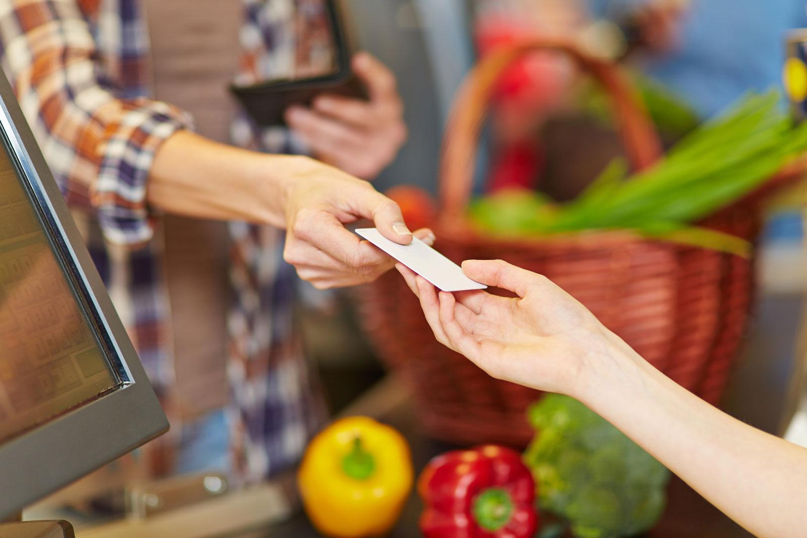 Person buying vegetables at the grocery store.