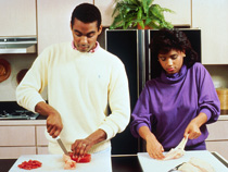couple cutting meat