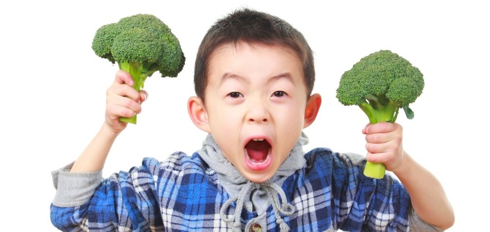 child with broccoli