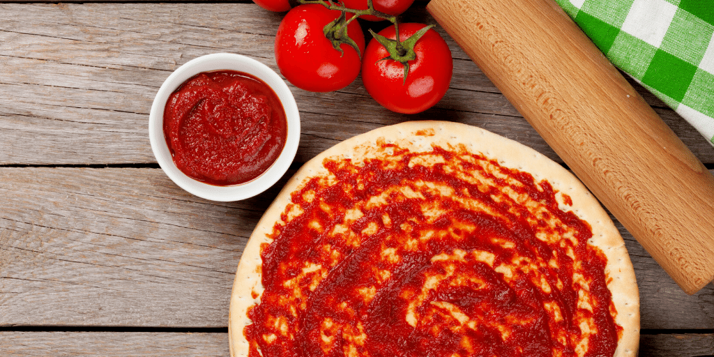 pizza crust with sauce and tomatoes