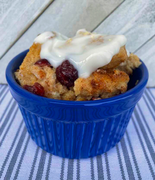 bread pudding topped with yogurt in a blue bowl