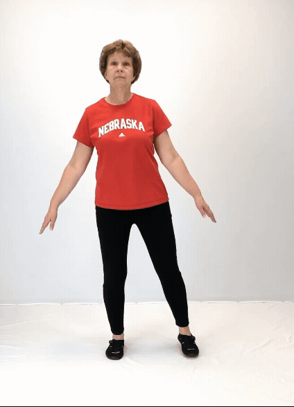 An individual modeling how to do a rock the boat exercise.
