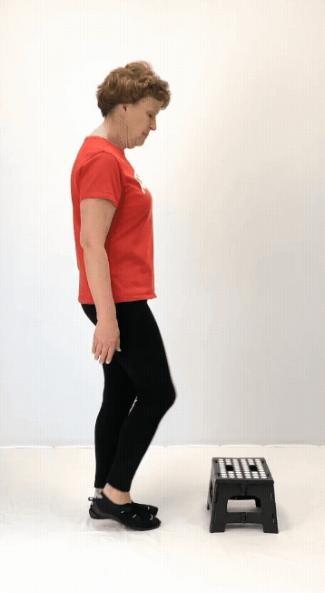 An individual modeling how to do a toe taps exercise.