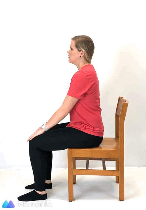 An individual modeling how to do a modified cow yoga pose.