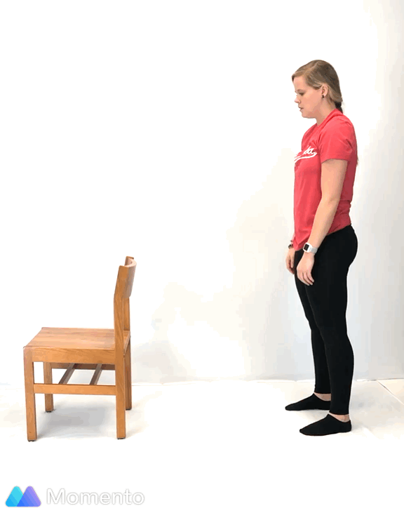 An individual modeling how to do a modified downward dog yoga pose.