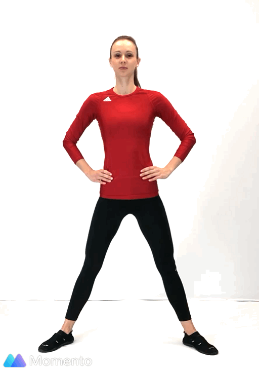 An individual modeling how to do a plié squat workout.
