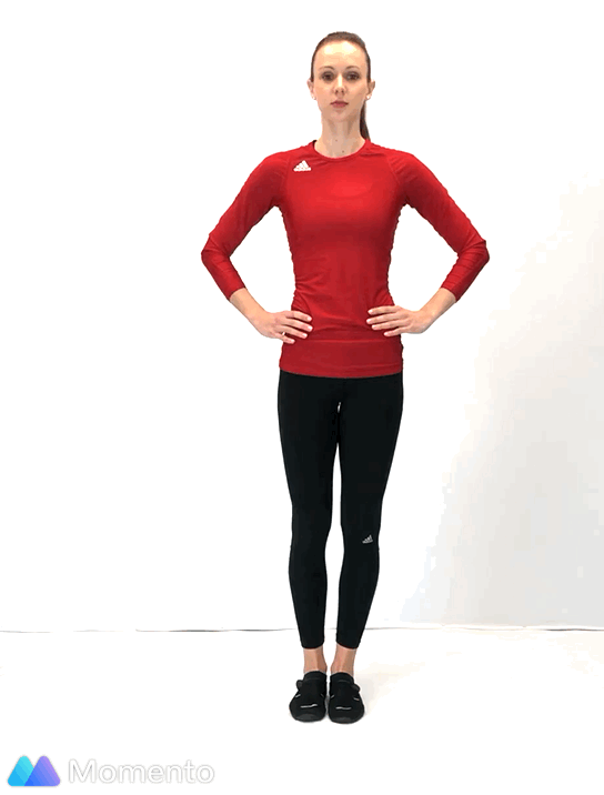 An individual modeling how to do a side leg lift exercise.