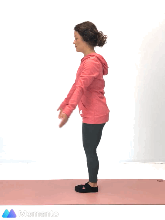 An individual modeling how to do a chair yoga pose