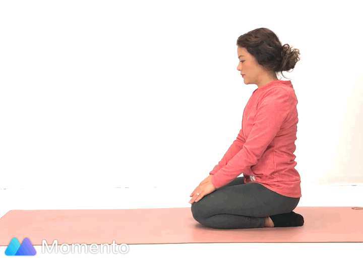 An individual modeling how to do a Childs yoga pose.