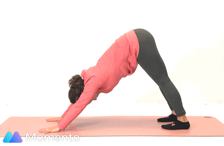 An individual modeling how to do a pigeon yoga pose.