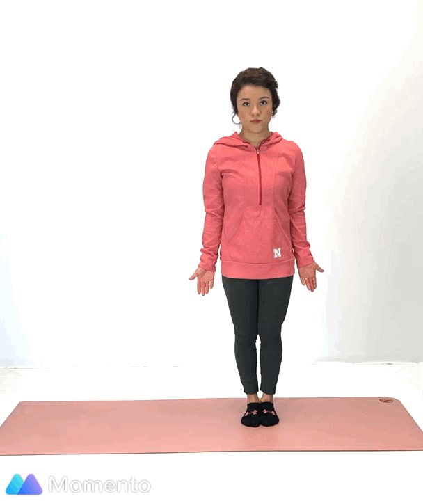 An individual modeling how to do a triangle yoga pose.