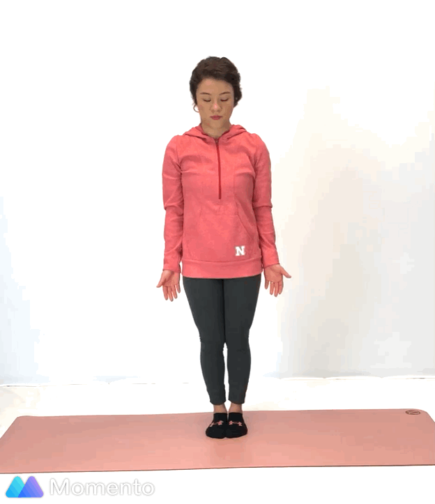 An individual modeling how to do a warrior I yoga pose.