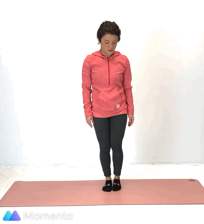 An individual modeling how to do a warrior II yoga pose.