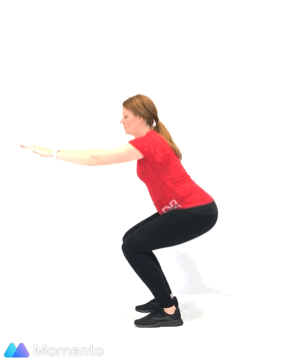 A pregnant women modeling how to do a squat exercise.