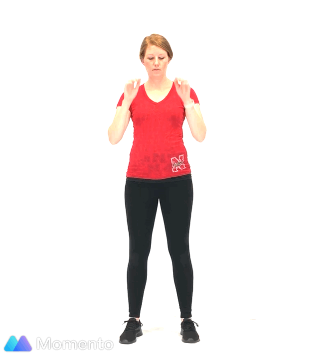 A pregnant women modeling how to do a star squat exercise without jumping.