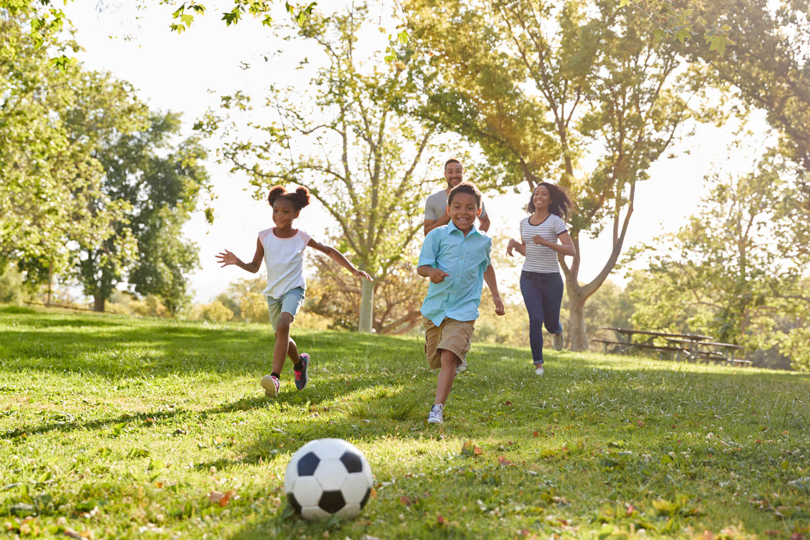 Family playing soccer together.