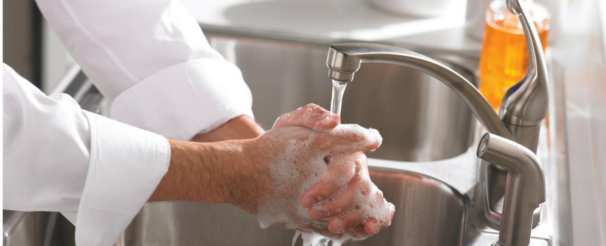 Person washing their hands.