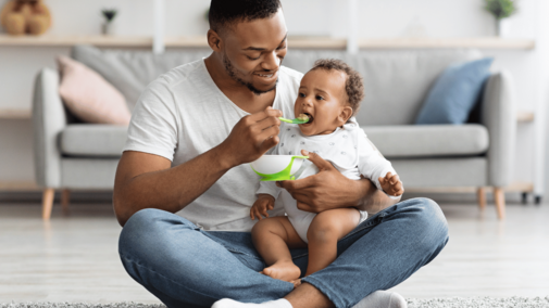 father feeding child