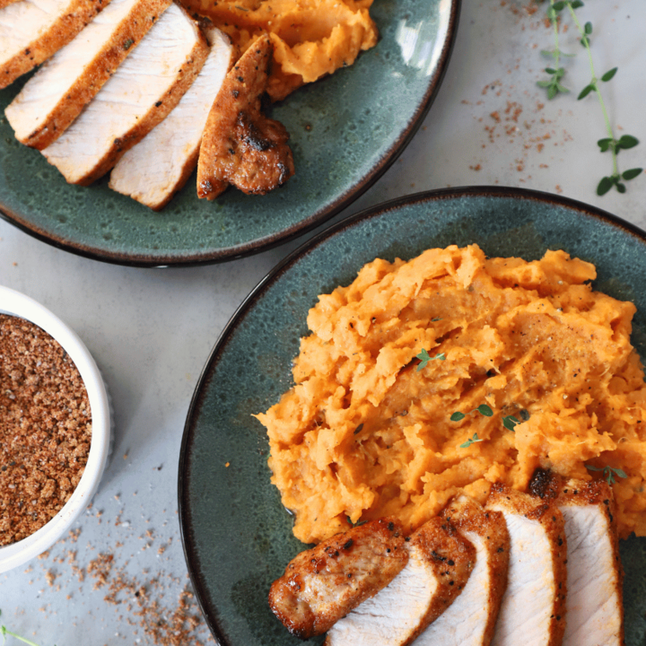 Sliced pork chops with mashed sweet potatoes on a plate