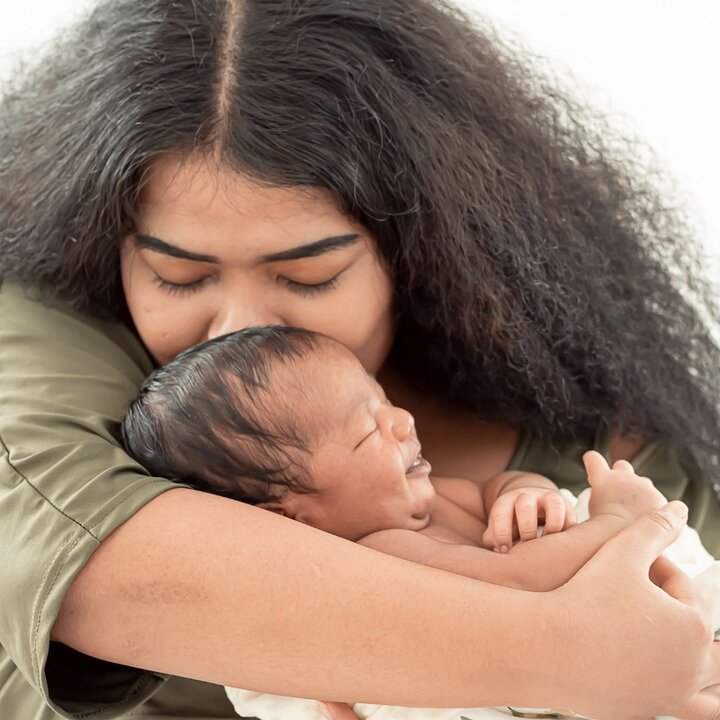 mom giving baby a hug