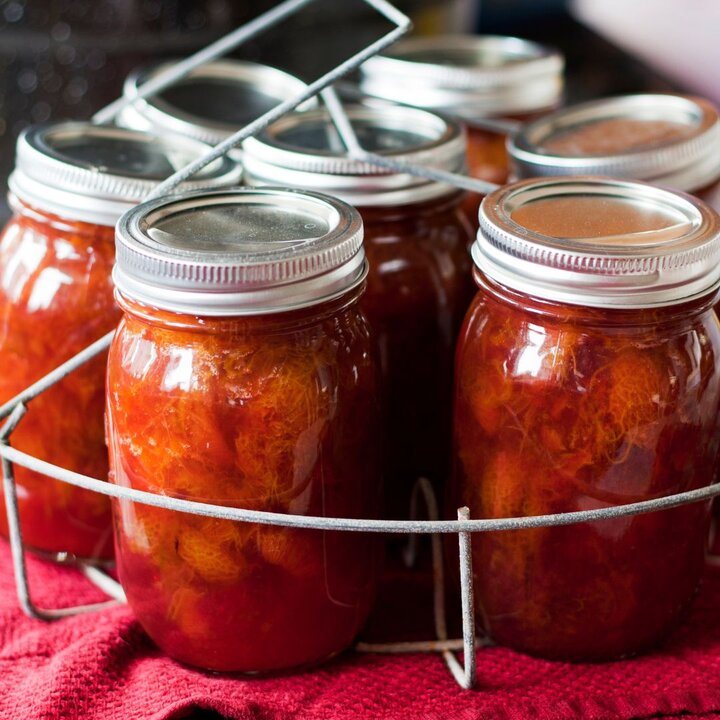 canned tomatoes in a rack on a towel