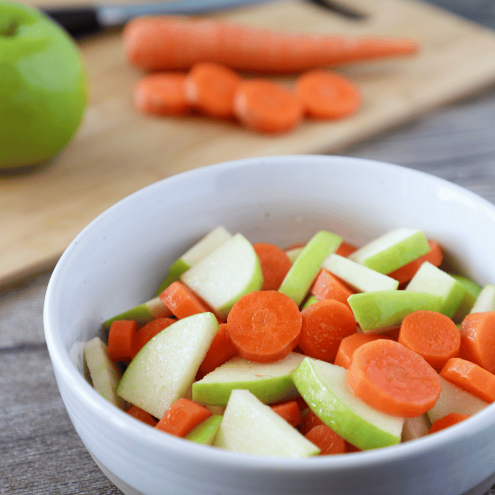 Carrot and apple salad in a white bowl