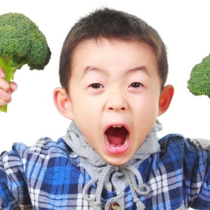 child with broccoli