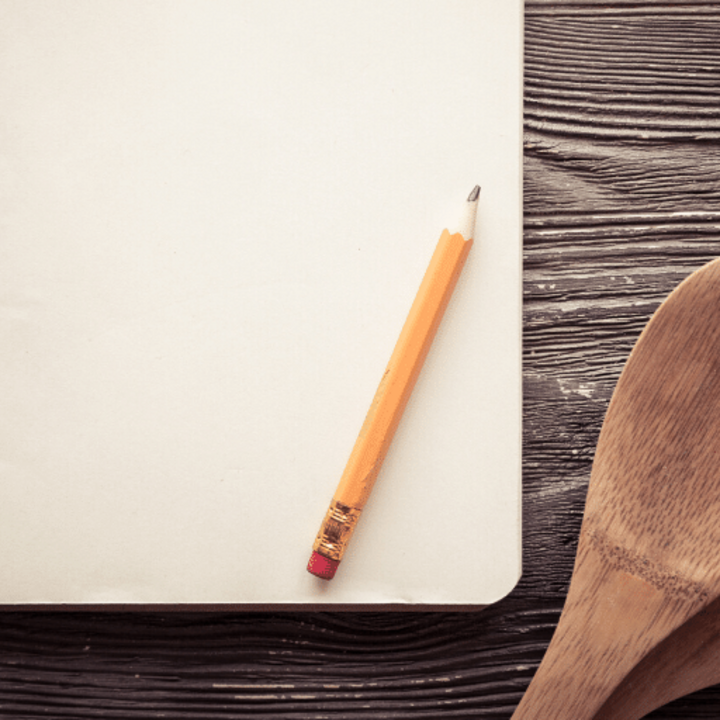 notebook with pencil for reducing size of recipes and cooking utensils