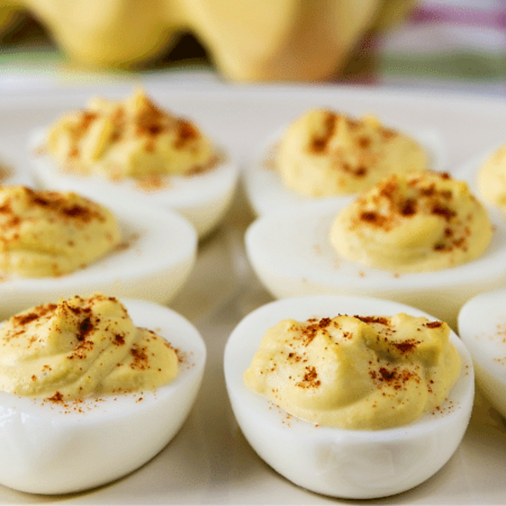 deviled eggs with paprika on a plate