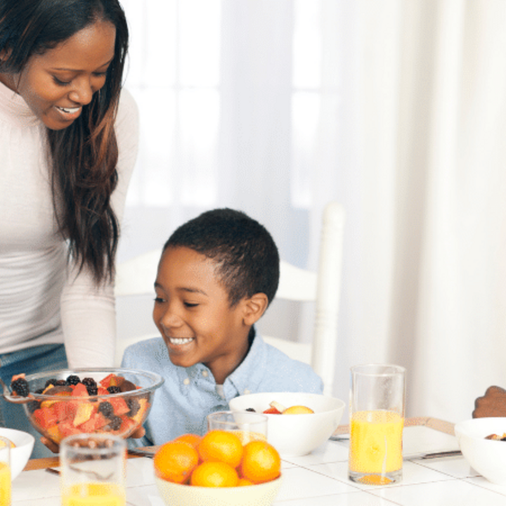 family sitting together at kitchen table for a meal