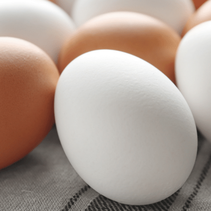 brown and white eggs on a table cloth