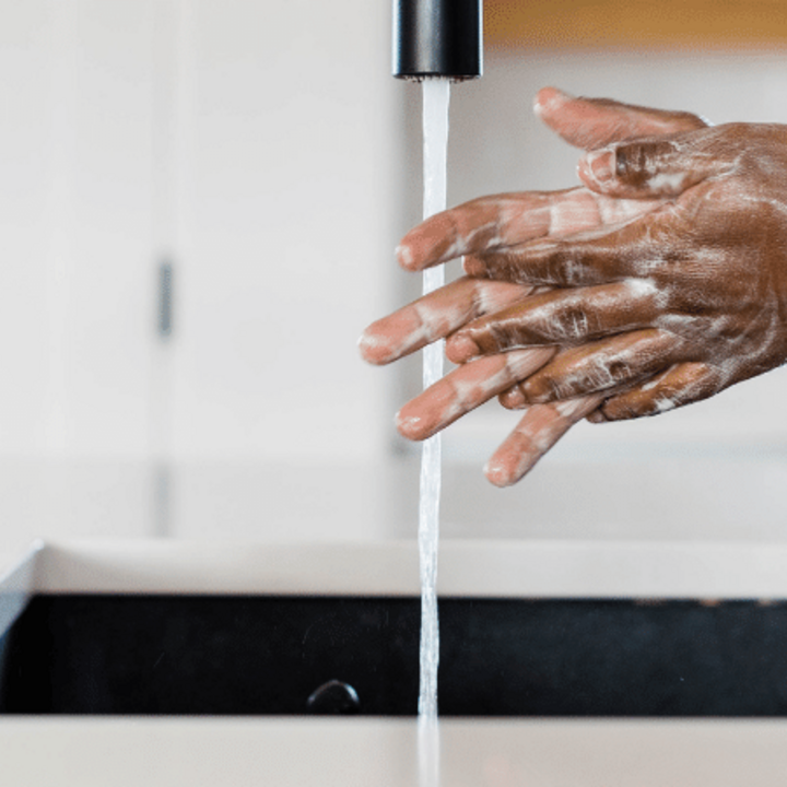 man washing hands with soap and water