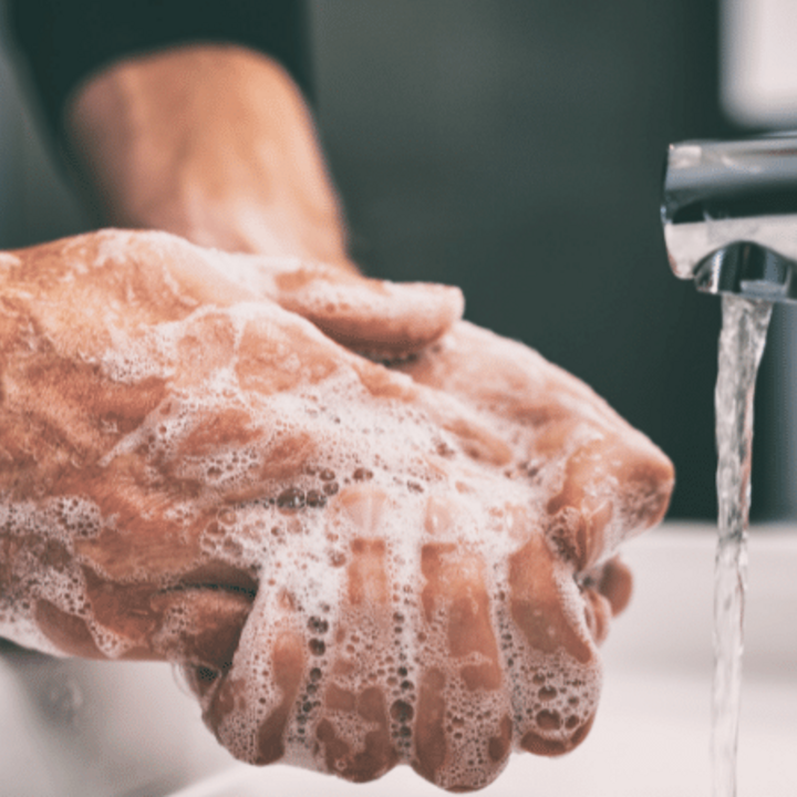 man washing hands with soap and water