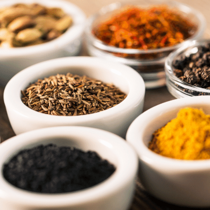 variety of herbs and spices in bowls