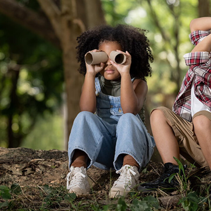 children sitting in the forest