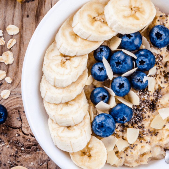 bowl of oatmeal with bananas, blueberries, and almonds