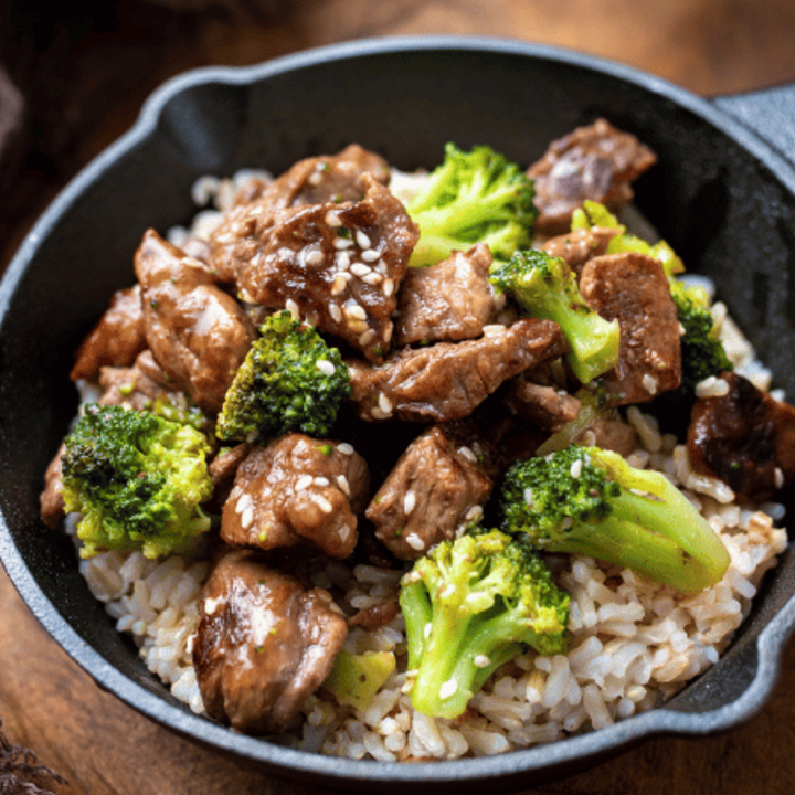 beef broccoli with rice in a skillet