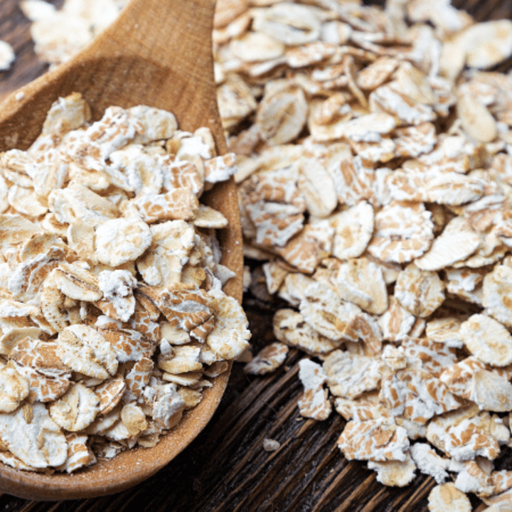 raw oatmeal in a spoon on a table