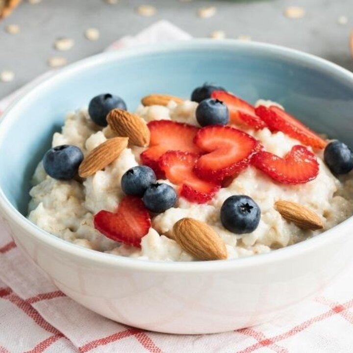 oatmeal in a bowl with strawberries and blueberries