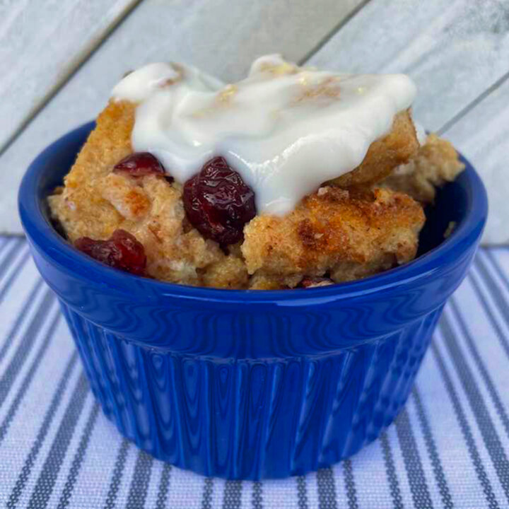 bread pudding topped with yogurt in a blue bowl