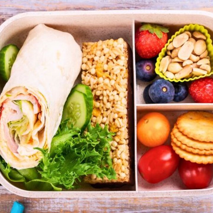 packed lunch with apple, wrap and water