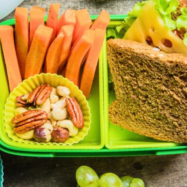 packed lunch with sandwich, banana, carrots, nuts, blueberries