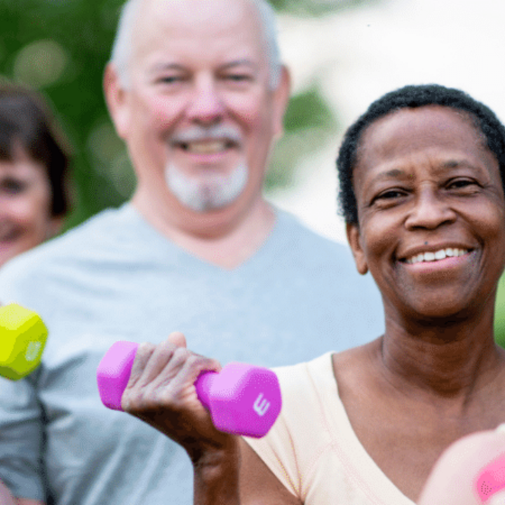 older adults lifting dumbbells