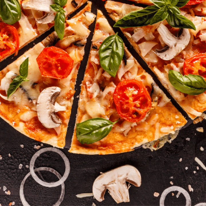 Italian pizza with mushrooms, tomatoes, onion, and basil