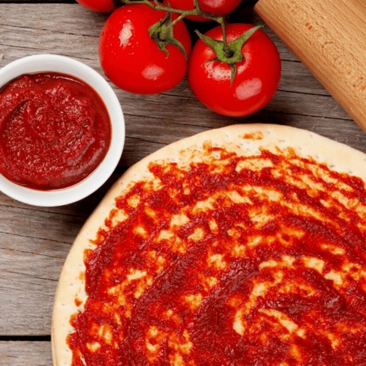 pizza crust with sauce and tomatoes